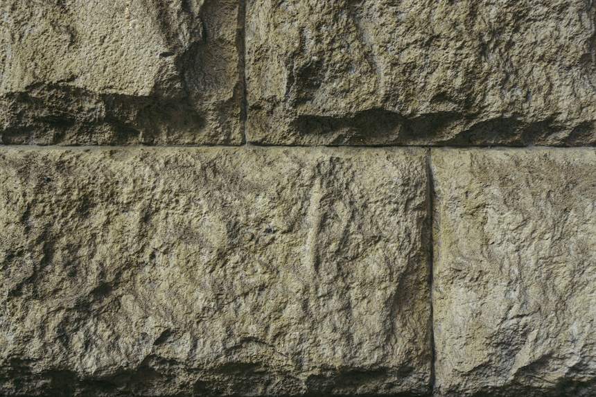 Large hand-tooled sandstone blocks in a wall