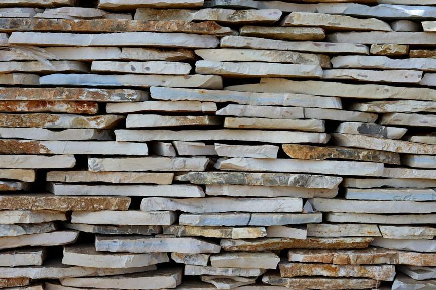 Reclaimed stone flags stacked edge on, buff and grey