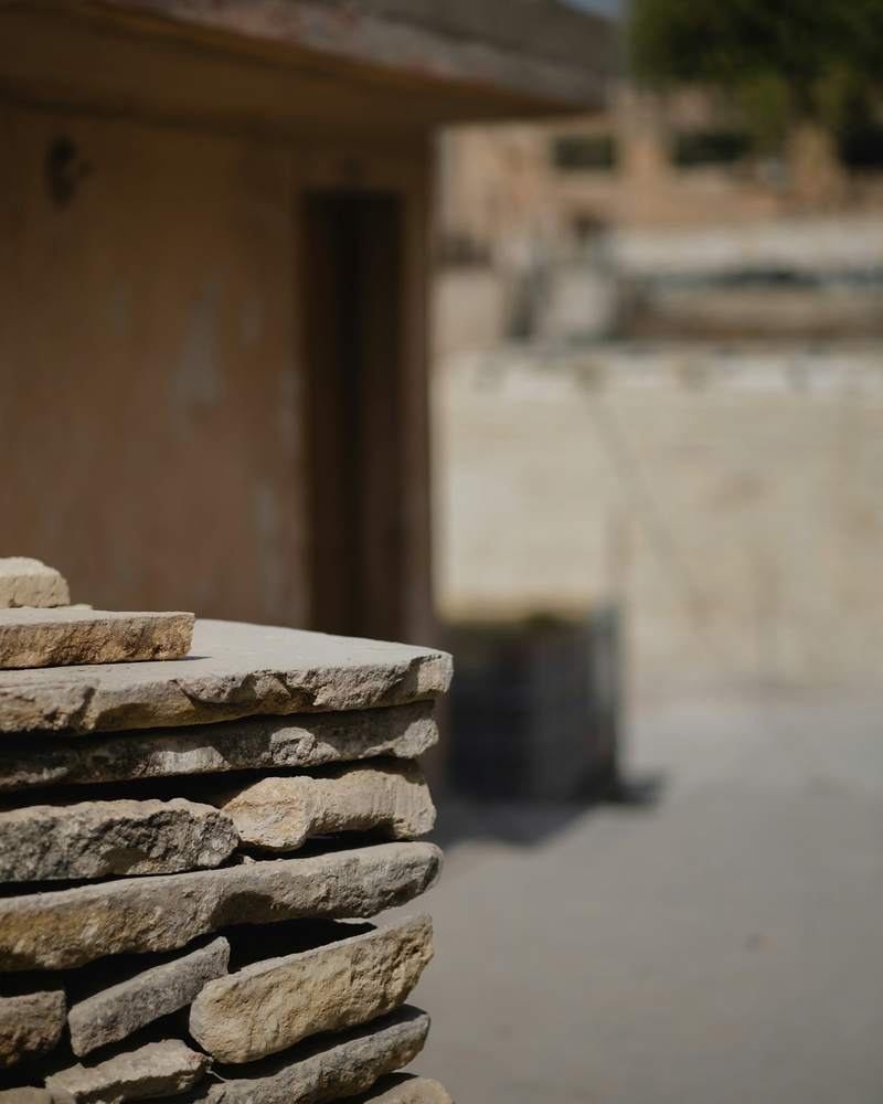 Reclaimed stone flags stacked on a pallet in the yard